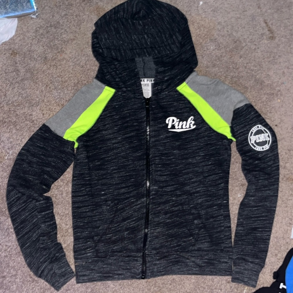 pink branded black zip-up with green and grey lines on shoulders